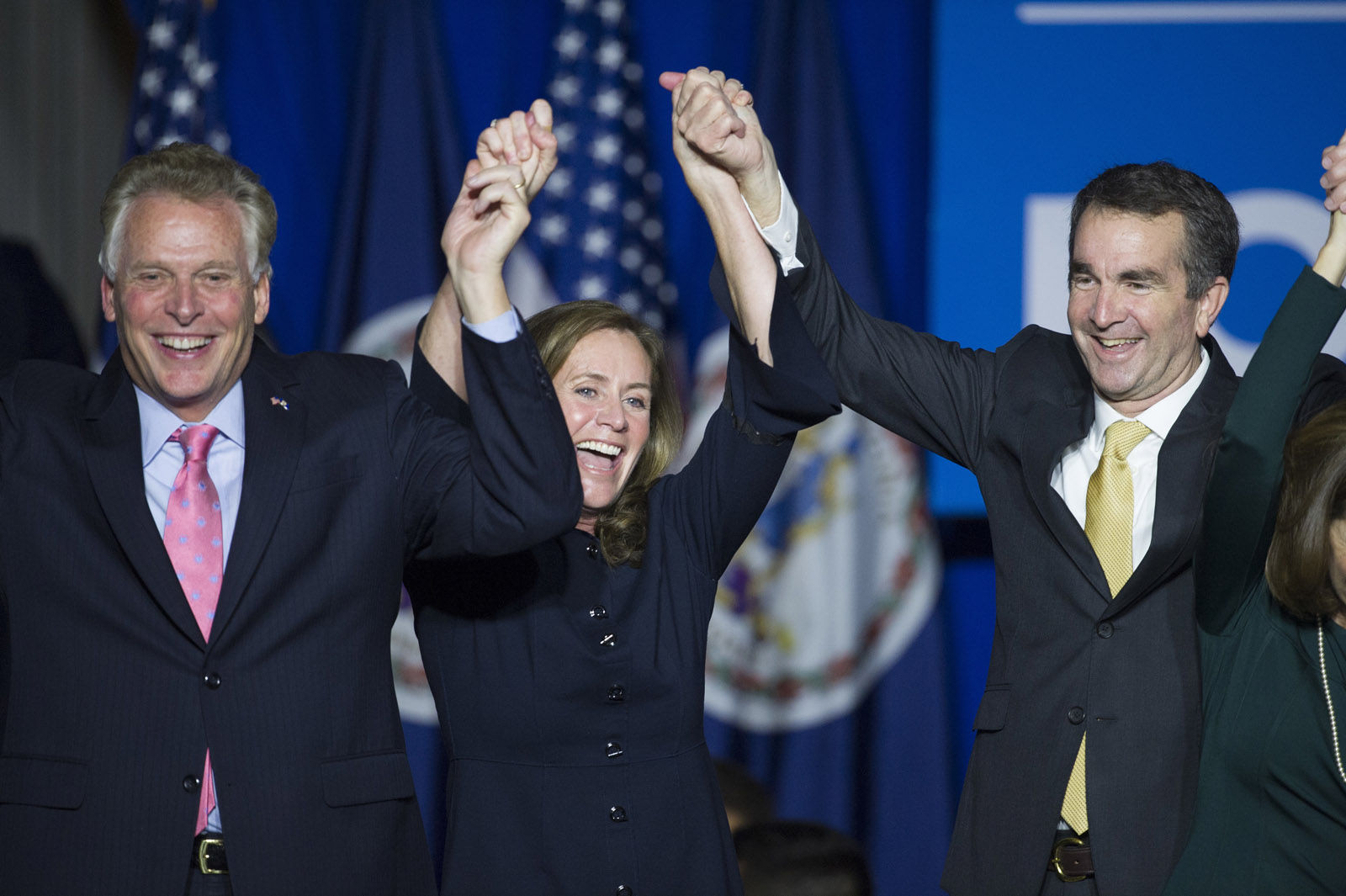 Virginia Gov.-elect Ralph Northam, right, celebrates his election victory with Virginia Gov. Terry McAuliffe and his wife Dorothy at the Northam For Governor election night party at George Mason University in Fairfax, Va., Tuesday, Nov. 7, 2017. (AP Photo/Cliff Owen)