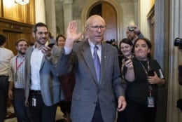 With reporters seeking comment, Republican Senator Pat Roberts of Kansas, chairman of the Senate Agriculture Committee, departs after he opened and closed a brief session of the U.S. Senate amid the partial government shutdown, at the Capitol in Washington, Thursday, Dec. 27, 2018. (AP Photo/J. Scott Applewhite)