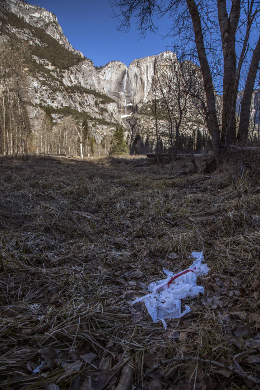 In this Monday, Dec. 31, 2018 photo provided by Dakota Snider shows trash tossed on the grounds in Yosemite National Park, Calif. Human feces, overflowing garbage, illegal off-roading and other damaging behavior in fragile areas were beginning to overwhelm some of the West's iconic national parks on Monday, as a partial government shutdown left the areas open to visitors but with little staff on duty. (Dakota Snider via AP)