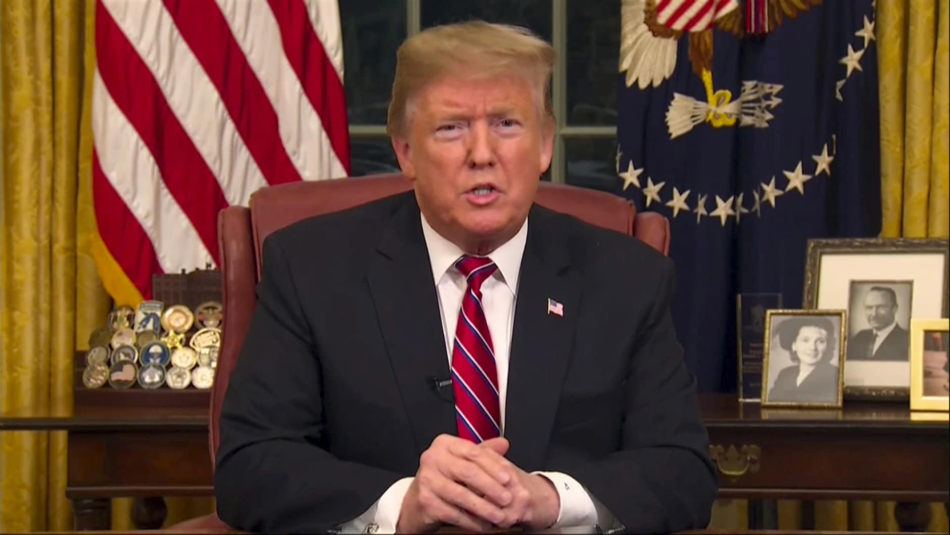 In this image from video, President Donald Trump speaks during a televised address from the Oval Office of the White House in Washington on Tuesday, Jan. 8, 2019. (Pool Photo via AP)