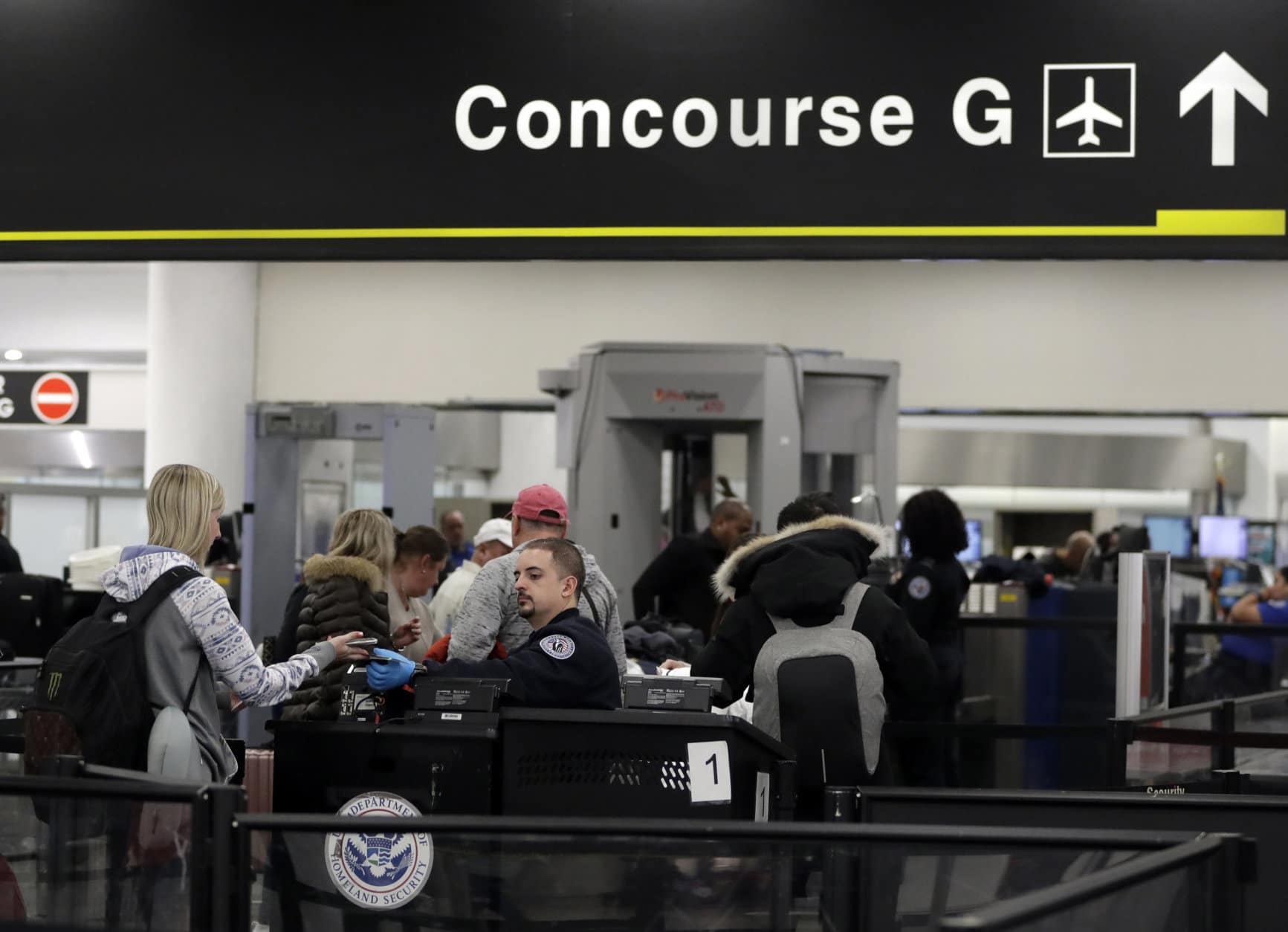 A Transportation Security Administration officer works at the entrance to Concourse G at Miami International Airport, Friday, Jan. 11, 2019, in Miami. The airport is closing Terminal G this weekend as the federal government shutdown stretches toward a fourth week because security screeners have been calling in sick at twice the airport's normal rate. (AP Photo/Lynne Sladky)