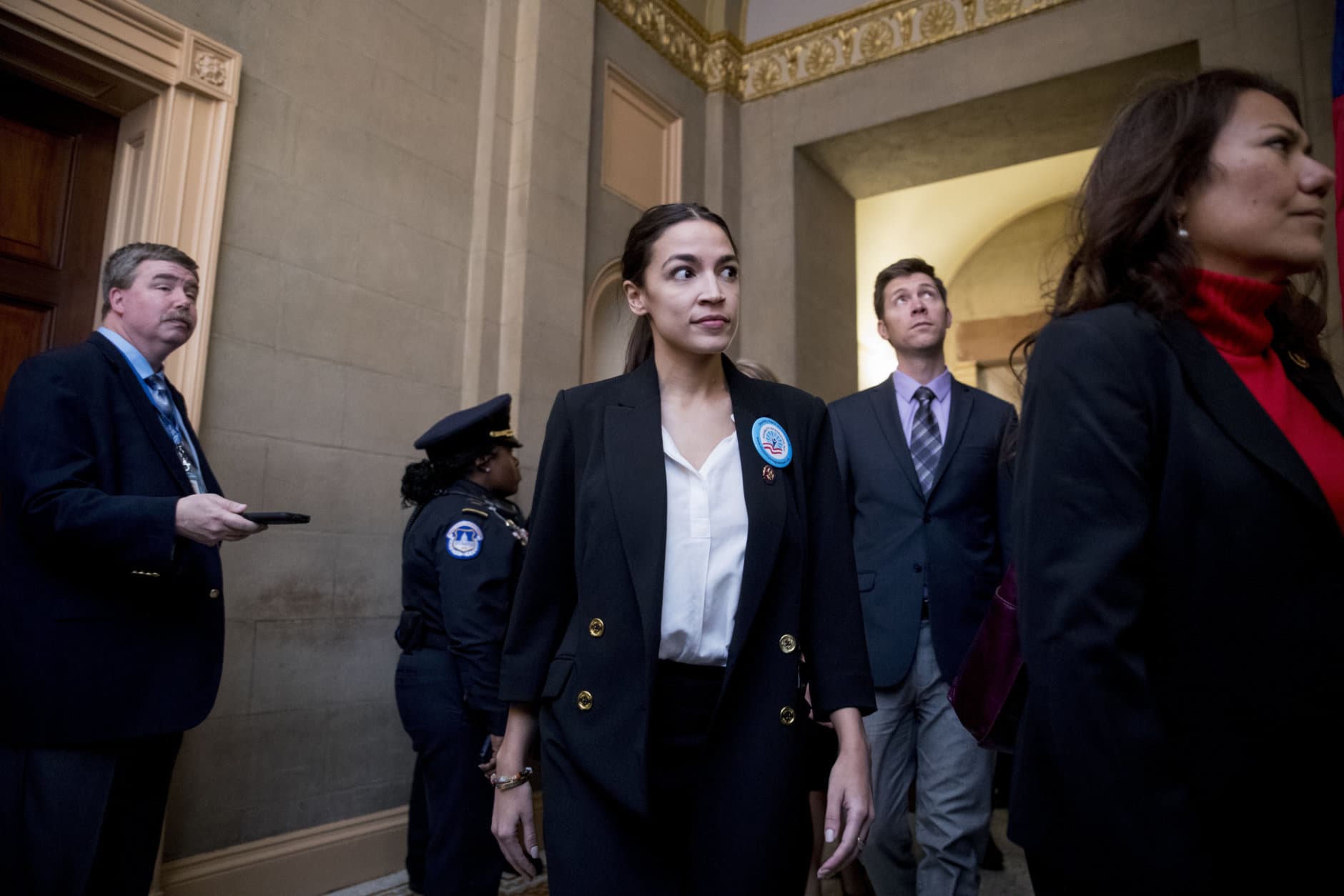Rep. Alexandria Ocasio-Cortez, D-N.Y., center, and Rep. Veronica Escobar, D-Texas, right, and other freshman Congressmen deliver a letter calling to an end to the government shutdown to the office of Senate Majority Leader Mitch McConnell of Ky., on Capitol Hill in Washington, Wednesday, Jan. 16, 2019. (AP Photo/Andrew Harnik)