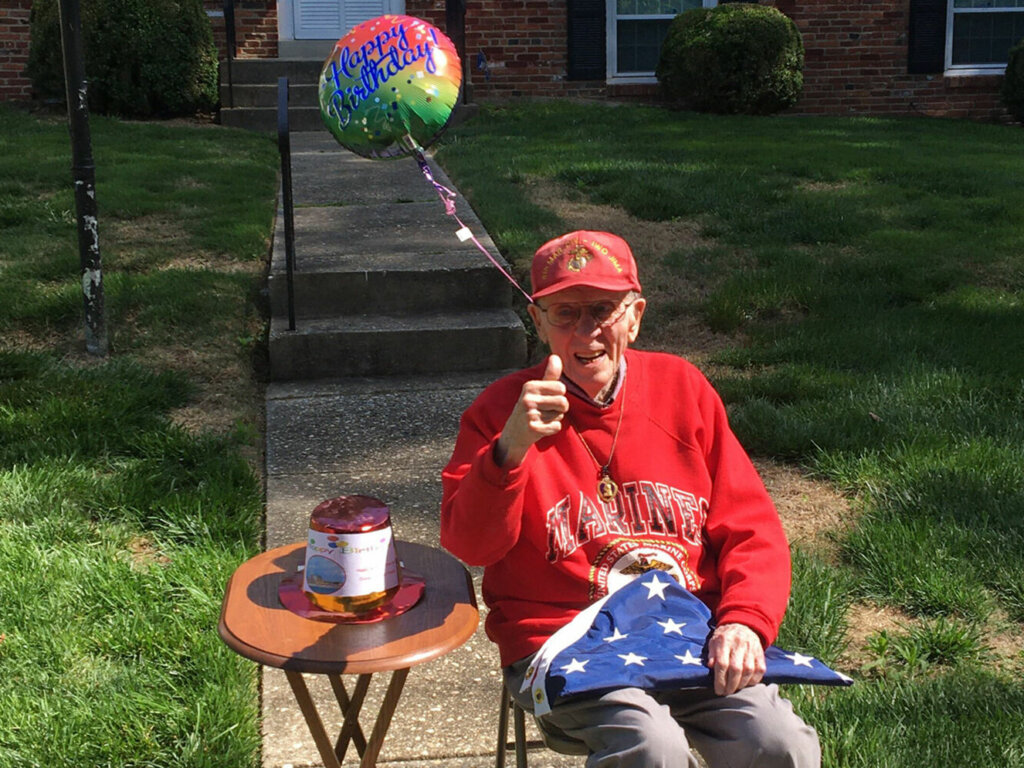 Man with folded American flag.
