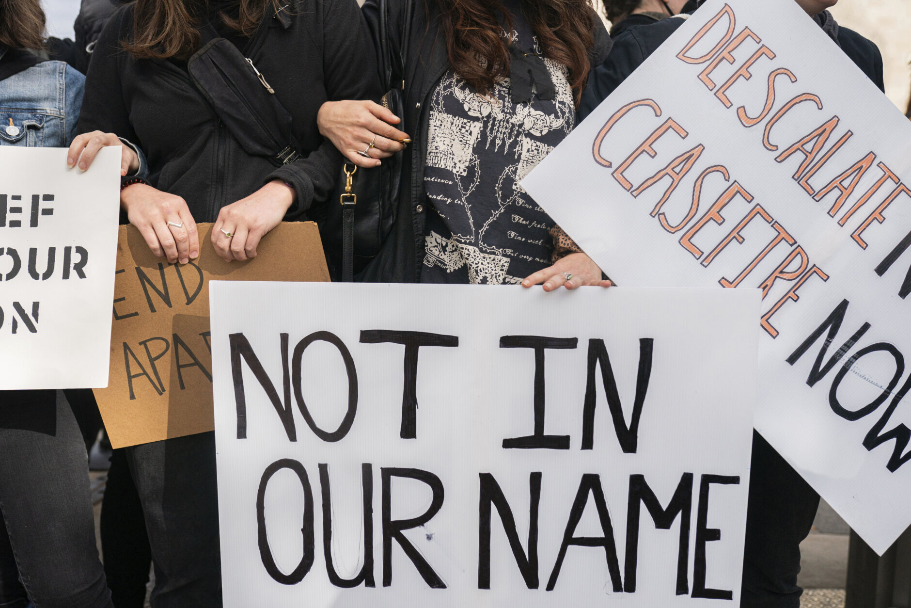 Protesters calling for a ceasefire in Gaza block the 15th street entrance to the White House in Washington, Monday, Oct. 16, 2023. (AP Photo/Nathan Howard)