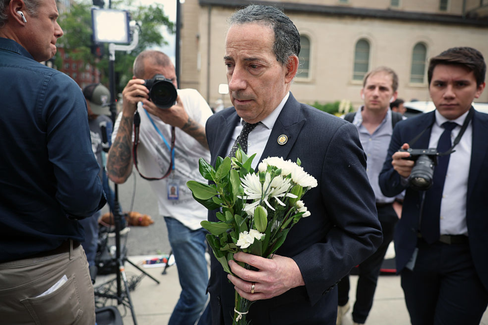 U.S. Rep. Jamie Raskn (D-MD) leaves flowers at the site of the recent shooting at the Lillian and Albert Small Capital Jewish Museum on May 22, 2025 in D.C.